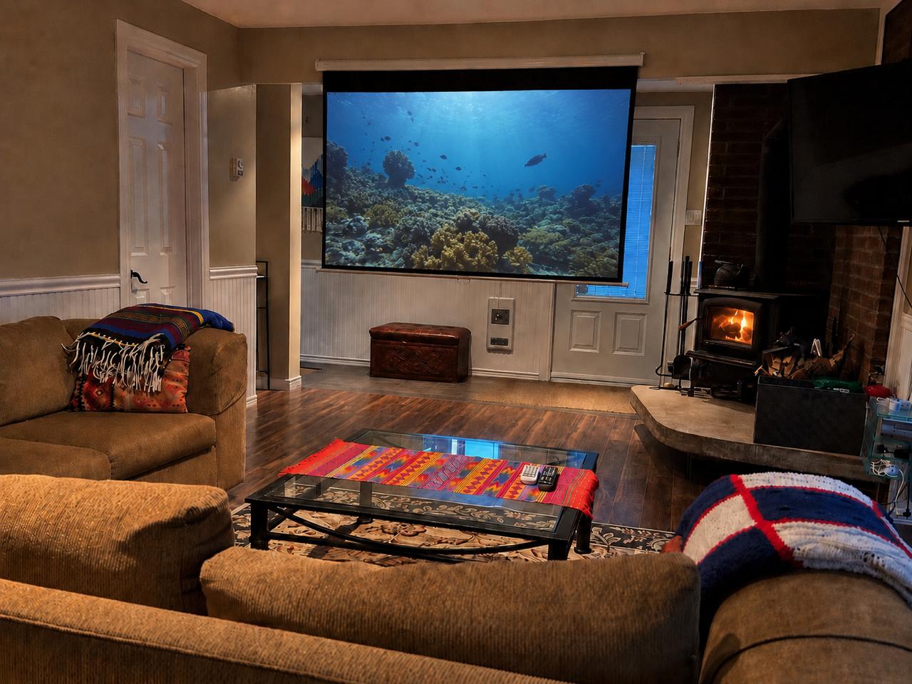 Cinema projector screen and wood stove in the living room